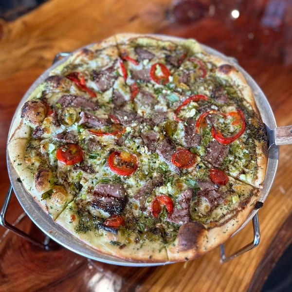 Cold Springs Crossing Bar & Grill's pizza with pesto, steak, red peppers, and feta cheese.