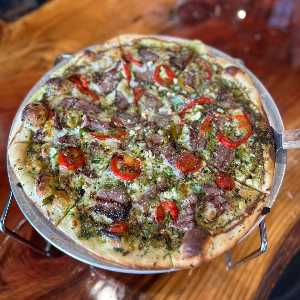 Cold Springs Crossing Bar & Grill's pizza with pesto, steak, red peppers, and feta cheese.